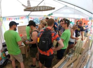 A group of people viewing the exhibits in the BCI stand at Glastonbury Festival 2022